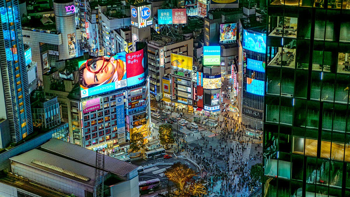 Shibuya Crossing at night with neon signs